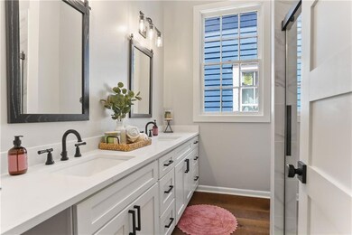 Primary bathroom with double vanities and large sh