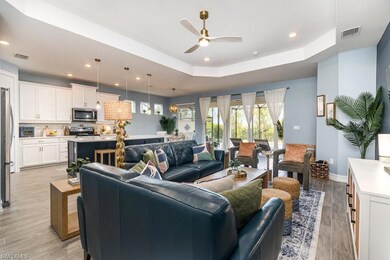 Living room with a raised ceiling and ceiling fan