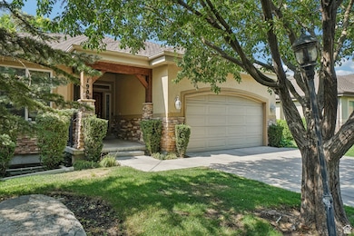Obstructed view of property with stone siding, stucco siding, concrete driveway, a garage, and a front yard