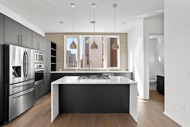 Kitchen featuring stainless steel appliances, lig