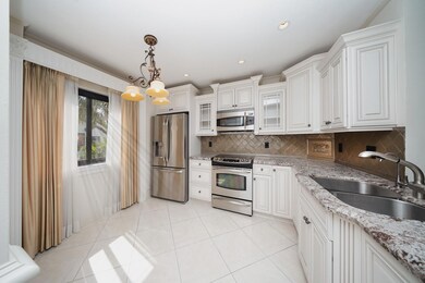 The kitchen has lovely custom cabinets, stainless