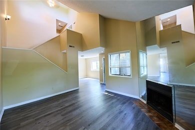 Unfurnished living room featuring dark wood finish