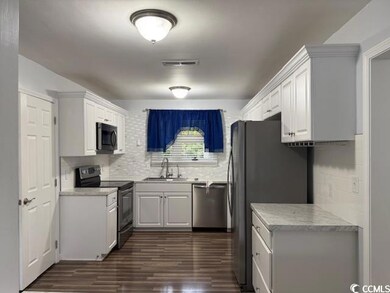 Kitchen featuring decorative backsplash, stainless