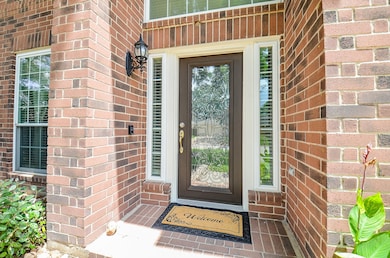 The welcoming brick entryway features an impressiv