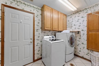 Laundry room right off kitchen has cabinetry & bui