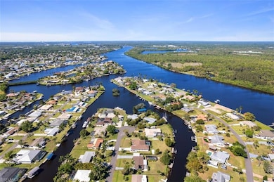 Aerial overview of property's location featuring a large body of water and nearby suburban area