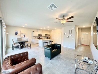 Living room featuring baseboards, ceiling fan, rec