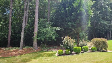 View of grassy yard featuring a forest view