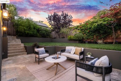 Fenced backyard with outdoor lounge area, stairs, and a patio