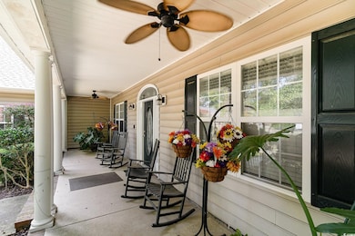 Covered front porch featuring ceiling fan