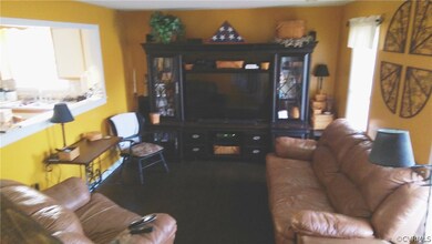 Living Room with laminate floor, coat closet and p