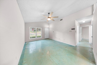 Empty room featuring finished concrete flooring, 