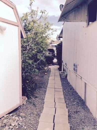 Rear of subject property & walkway to storage shed