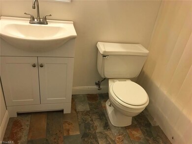 2nd bathroom with new tile floor, vanity and sink.