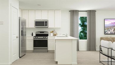 Kitchen featuring white cabinets, sink, appliances