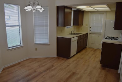 Kitchen with white appliances, light countertops,
