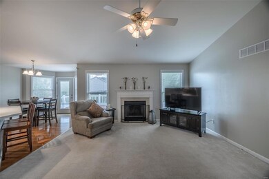 Open great room with fireplace and vaulted ceiling