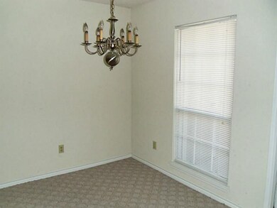 Dining area overlooks balcony & common grassy  are