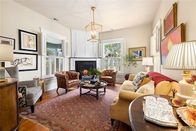 The TV is in a hidden cabinet above the fireplace.  Three out of the five original hand blown glass windows which have been sealed for energy efficiency