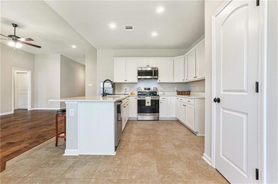 Open floor plan with bar seating and large walk in