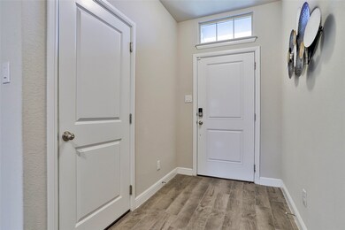 Doorway featuring wood finished floors and baseboards