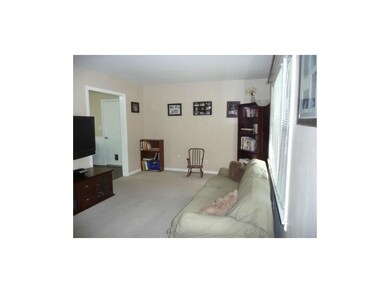 Updated living room with wide passage to kitchen