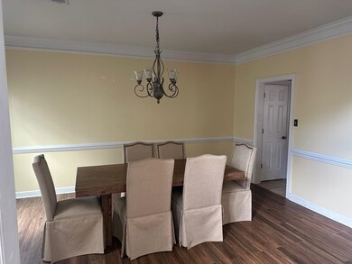 Unfurnished dining area featuring a chandelier, ba