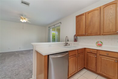 Kitchen featuring light carpet, kitchen peninsula,