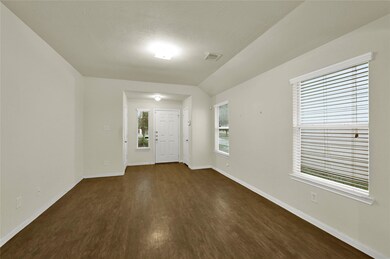 This is a spacious and bright room with neutral wa
