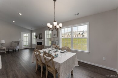 Dining space featuring an inviting chandelier, vau