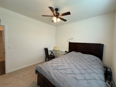 Bedroom featuring light carpet and ceiling fan