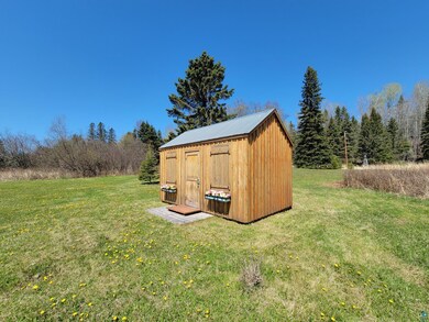 View of outdoor structure with a yard