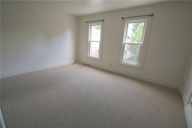 Living room empty with brand new carpet.