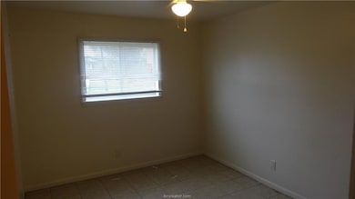 Spare room featuring a ceiling fan, baseboards, an