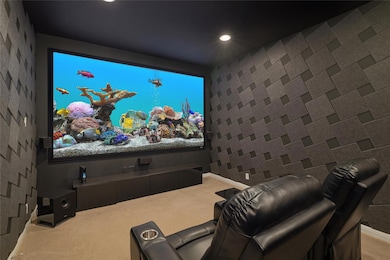 Carpeted home theater room featuring recessed lig