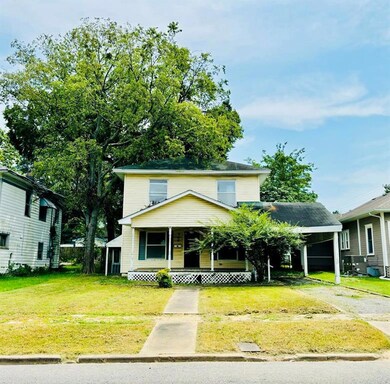 View of front property with covered porch, a carpo