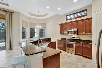 The kitchen features wood cabinetry, soft close dr