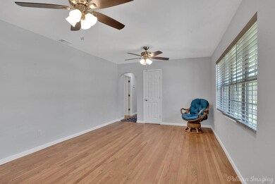 Living room with light hardwood / wood-style floor