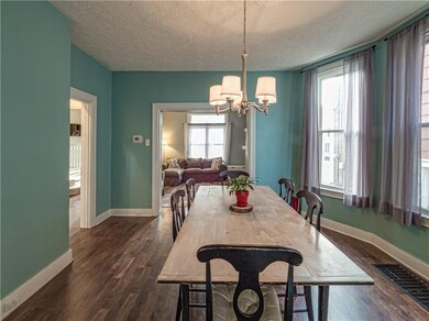 The sun filled open dining room features large win