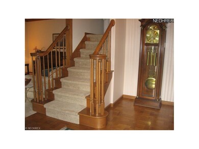 Spacious Foyer with custom parquet style hardwood 