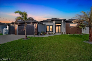 View of front facade with a garage, decorative dri