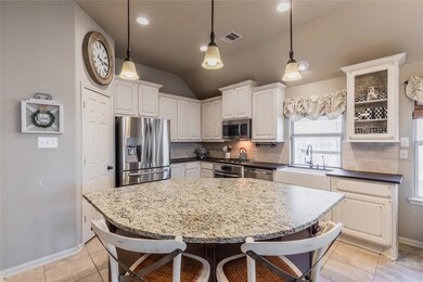 This kitchen is by far any chef’s dream! This spacious kitchen features a large window, high ceilings, white stained wood cabinets, honed granite countertops, SS appliances, tile backsplash, recessed lighting with additional custom pendant lighting, extended counter space, large kitchen island with space for bar seating, and a walk-in pantry all overlooking your huge family room.