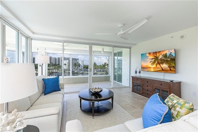 Living room with plenty of natural light, ceiling fan, and light tile patterned floors