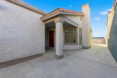 Doorway to property featuring stucco siding, a chimney, a tiled roof, and a patio area