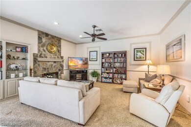 Family room featuring a fireplace, light carpet, b
