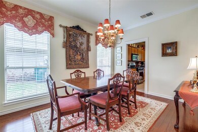 The formal dining room sits adjacent to the foyer 