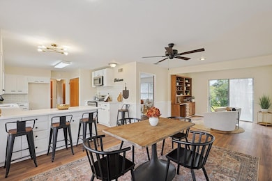 Dining room featuring sink, ceiling fan, and light hardwood / wood-style flooring