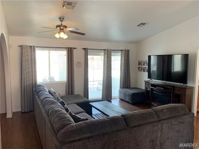 Living room featuring vaulted ceiling, dark hardwo