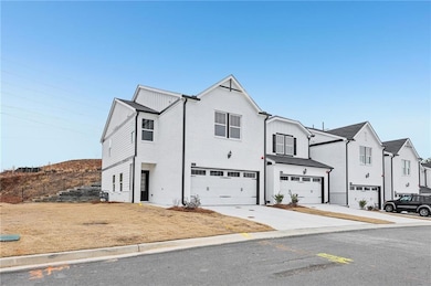 View of front of home with driveway, an attached g