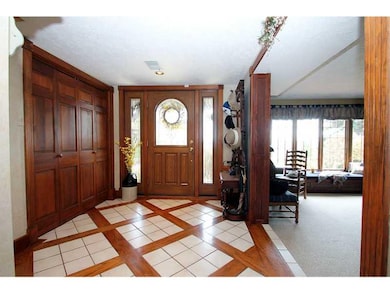 Entry/Foyer. Custom tile and hardwood floor